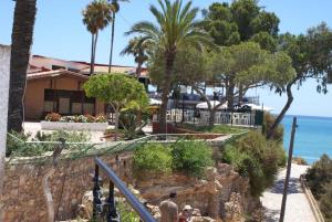 a man walking down a sidewalk next to a house at Oriheula Costa Cabo Roig 5 in Playas de Orihuela