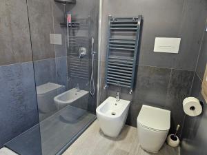 a bathroom with a toilet and a sink at EdenGHouse in Cordenons +5 photos