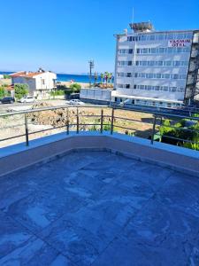 a view of the beach from the balcony of a building at Sea View Villa w Garden 50m to Sarımsaklı Beach in Ayvalık