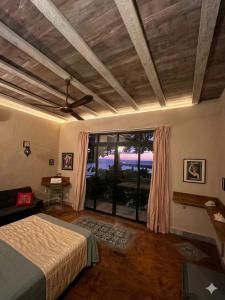 a bedroom with a bed and a large window at Habitación, balcón frente al mar y alberca in Lerma