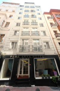 a tall white building with a pera apartment hotel at Pera Arya Hotel in Istanbul