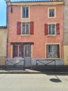 a red brick building with windows and a door at Les 3 suites in Issoire