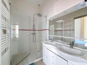 a white bathroom with a sink and a shower at Le Cours Langlet B in Reims