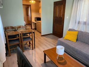 a living room with a couch and a table at Amarynthos Tiny Retreat in Amarynthos