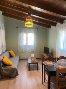 a living room with a couch and a table at Amarynthos Tiny Retreat in Amarynthos
