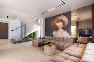 a living room with a couch and a painting at Villa Loparia in Lopar
