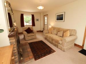 a living room with a couch and two chairs at Sarah's Cottage in Berwick-Upon-Tweed