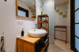 a bathroom with a white sink on a wooden counter at Casa.Peiso in Mörbisch am See +87 photos