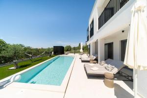 a villa with a swimming pool and a house at Villa Loparia in Lopar