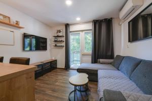 a living room with a couch and a table at Apartment Niksa in Pula