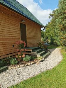 a building with steps leading up to a door at Domek Las nad jeziorem in Bożepole Królewskie
