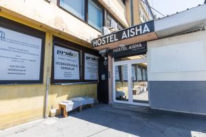 a store front with a bench outside of a building at AISHA Hostel in Ljubljana
