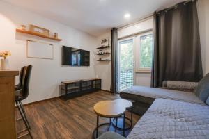 a living room with a couch and a table at Apartment Niksa in Pula