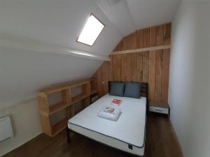 a small room with a bed in a attic at Les Hellébores in Égletons