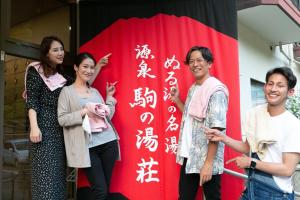 a group of people standing in front of a banner with writing at コテージひだまり in Izunokuni +108 photos