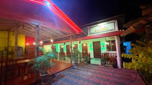 a restaurant with a neon sign on the side of it at Coral Moon in Trincomalee +4 photos