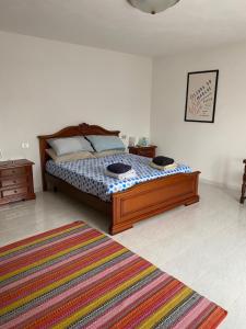a bedroom with a bed with a rug on the floor at Casale Vista Mutria in Vinchiaturo
