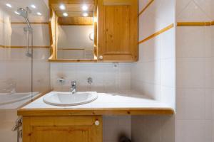 a bathroom with a sink and a shower at Appartement Airelles B25 in Levassaix +20 photos