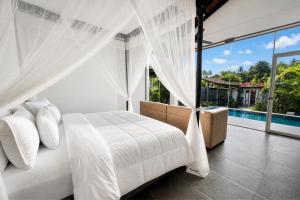 a bedroom with a white bed and a pool at Waterland in Negombo