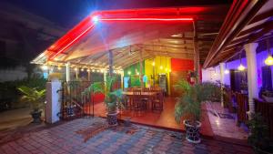 a restaurant with a lit up patio at night at Coral Moon in Trincomalee