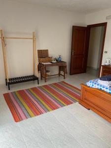 a bedroom with a bed and a table and a rug at Casale Vista Mutria in Vinchiaturo