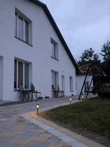 a white building with lights in front of it at Апарт Стефанія in Skhidnitsa