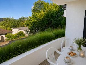 a white table and chairs on a balcony with a view at Ferienwohnung Seeblick 24 in Winterberg