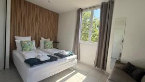 a bedroom with a bed with towels on it at Kimi Résidence in Cannes