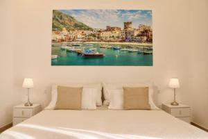 a bedroom with a bed and boats in the water at Villa Miriam in Gragnano
