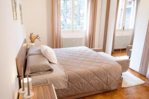 a small bedroom with a bed and a chair at Landi 14 - Air Conditioning, Private Parking, Premium Sleep in Medicina +34 photos