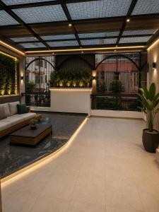 a living room with a couch and a table at Atlantiis Suites Inn By Signature Stays Near Vishwanath Temple Rathyatra in Kakarmatha