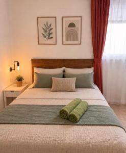 a bedroom with a bed with two green towels on it at Perello Old Town in Split