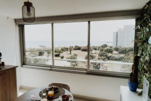 a room with a large window with a view of a city at Suite Katalanos & Spa in Le Barcarès