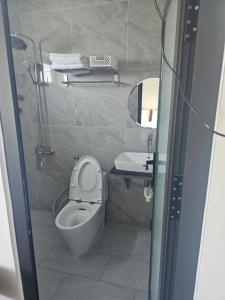 a bathroom with a toilet and a sink and a shower at Thái Bảo 4 Hotel in Quảng Ngãi