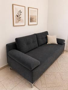 a black couch sitting in a living room at Perello Old Town in Split +27 photos