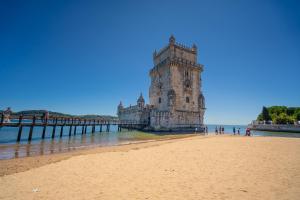 a building on the beach next to a pier at Kampaoh Lisboa in Lisbon
