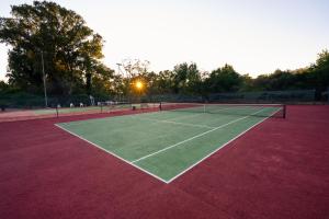 a tennis court with two tennis rackets on it at Kampaoh Lisboa in Lisbon
