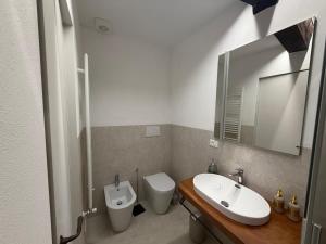 a bathroom with a sink and a toilet and a mirror at b&b K2R in Chiusdino +18 photos