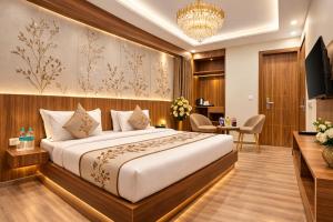a hotel room with a bed and a desk at Atlantiis Suites Inn By Signature Stays Near Vishwanath Temple Rathyatra in Kakarmatha