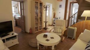 a living room with a tv and a table at Alba Andros Traditional Villa in Andros