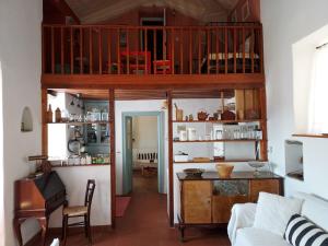 a room with a living room with a loft at Alba Andros Traditional Villa in Andros