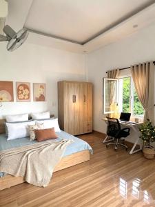 a bedroom with a bed and a desk with a computer at Hammer Homestay in Danang +26 photos