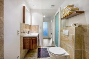 a bathroom with a toilet and a sink at Ferienwohnung Sophie in Ruhpolding +34 photos