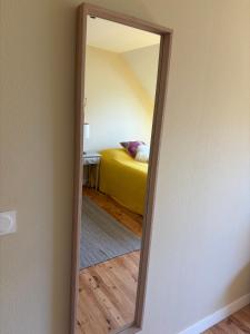 a mirror in a room with a bed at L'Atelier - Grande chambre d'hôtes in Caen