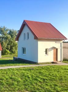 a small white house with a red roof at Lake House Moryn in Przyjezierze