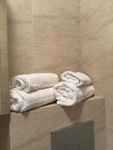 a pile of towels on a counter in a bathroom at Studio Apartament Cosmopolis P3B in Ştefăneştii de Sus