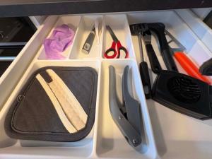 a drawer with scissors and other kitchen utensils at Notodden Sentrum Apartment NO 14 in Notodden