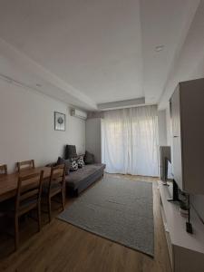 a living room with a couch and a table at Studio Apartament Cosmopolis P3B in Ştefăneştii de Sus