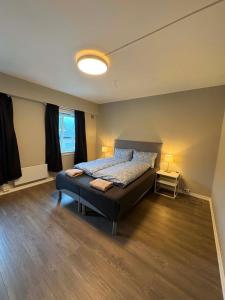 a large bedroom with a bed and a window at Notodden Sentrum Apartment NO 14 in Notodden