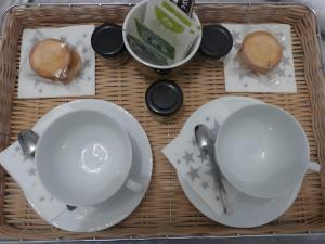 a table with white dishes and spoons on it at Entre Brionnais Et Bourbonnais in Montaigüet-en-Forez